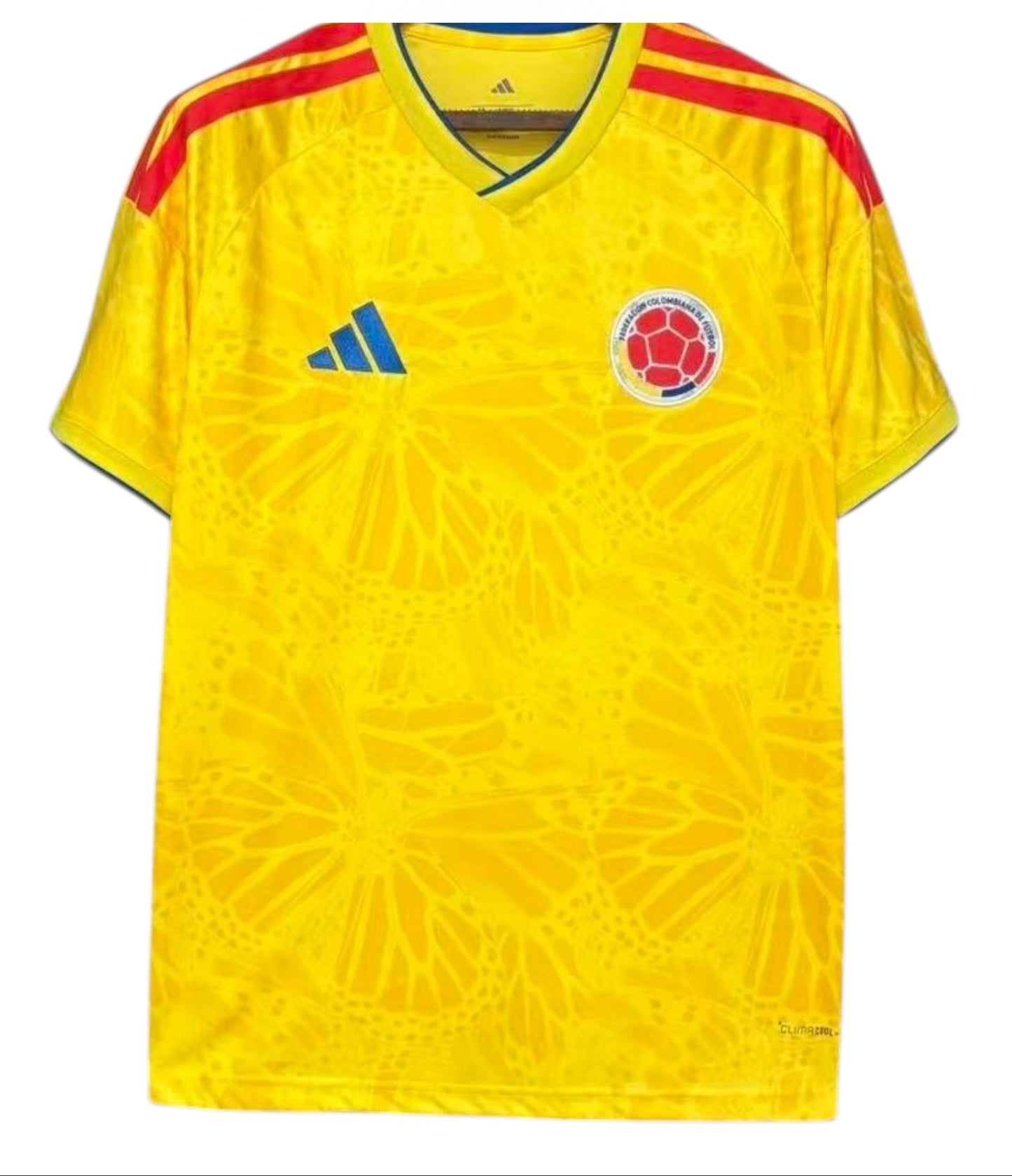 Yellow soccer jersey with red shoulders and Colombia national team logo, branded with Adidas, on a white background.